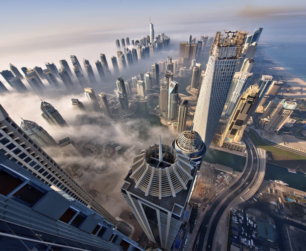 aerial view of cityscape with skyscrapers above the clouds in dubai, united arab emirates.,dubai, united arab emirates