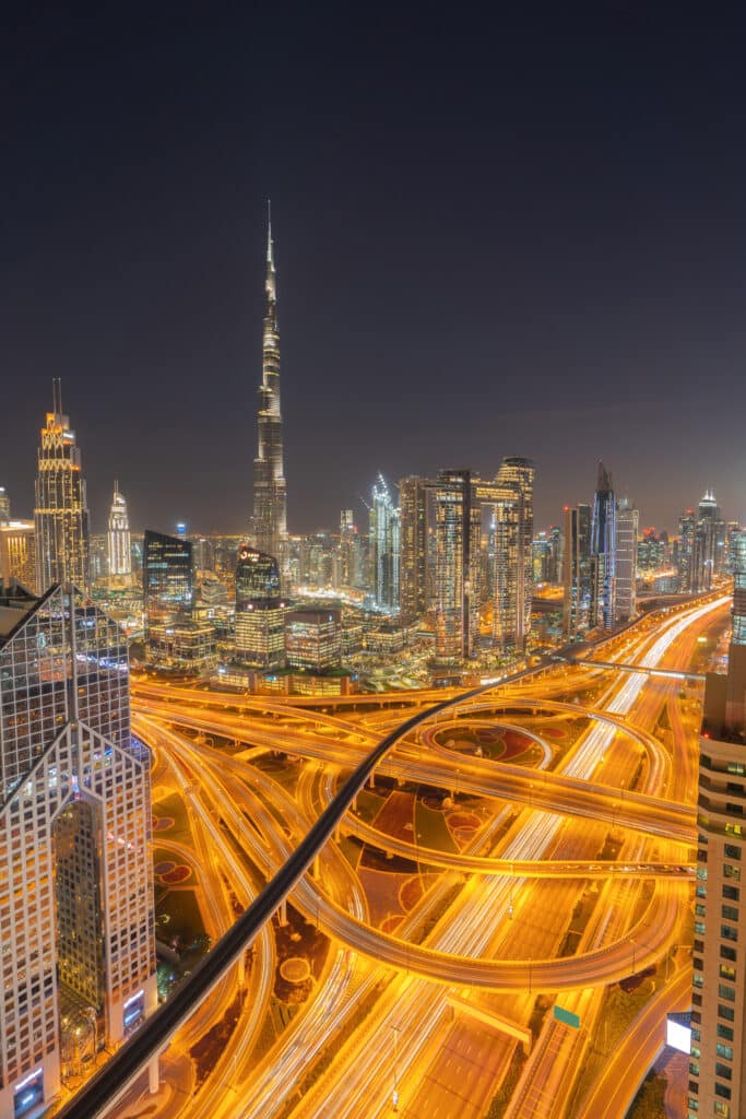 aerial view of dubai downtown skyline, highway roads or street in united arab emirates or uae. financial district and business area in smart urban city. skyscraper and high rise buildings at night.