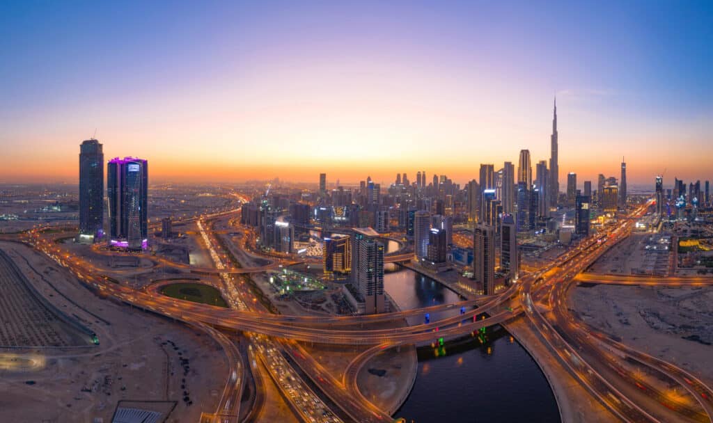 aerial view of burj khalifa in dubai downtown skyline and highway, united arab emirates or uae. financial district and business area in smart urban city. skyscraper and high rise buildings at night.